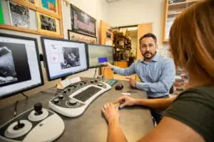 Professor Kellar explains image on computer screen to student