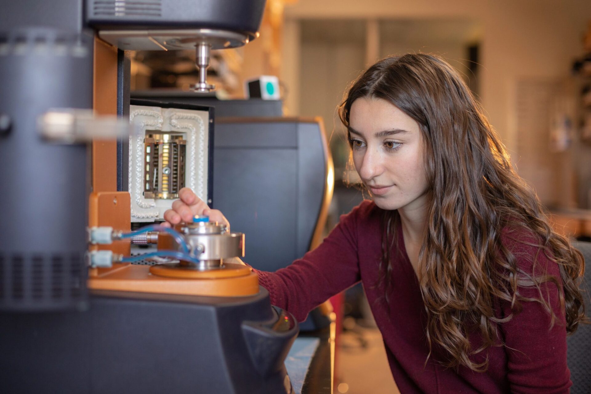 female grad student with long hair examines lab results in lab