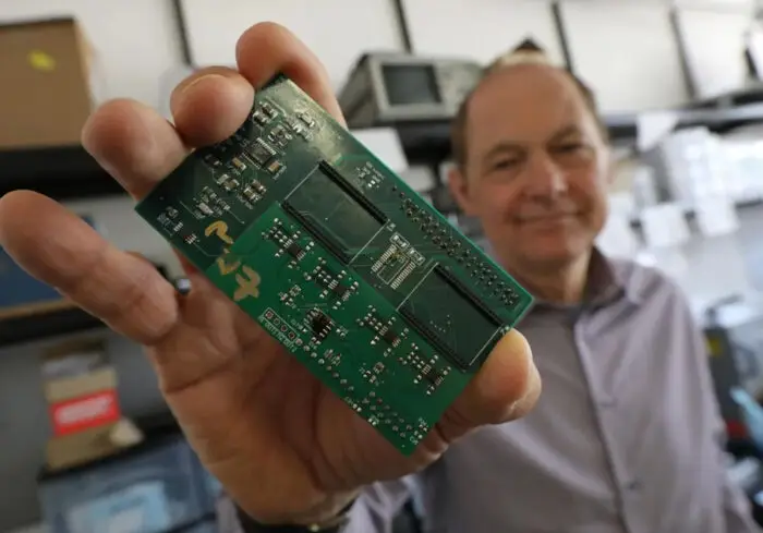 Professor Cambou shows a green hard drive