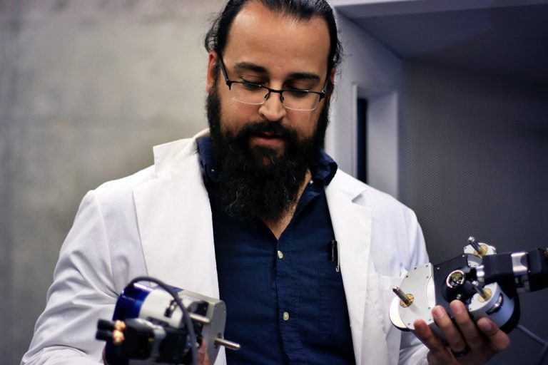 Grad student looks at two apparatus
